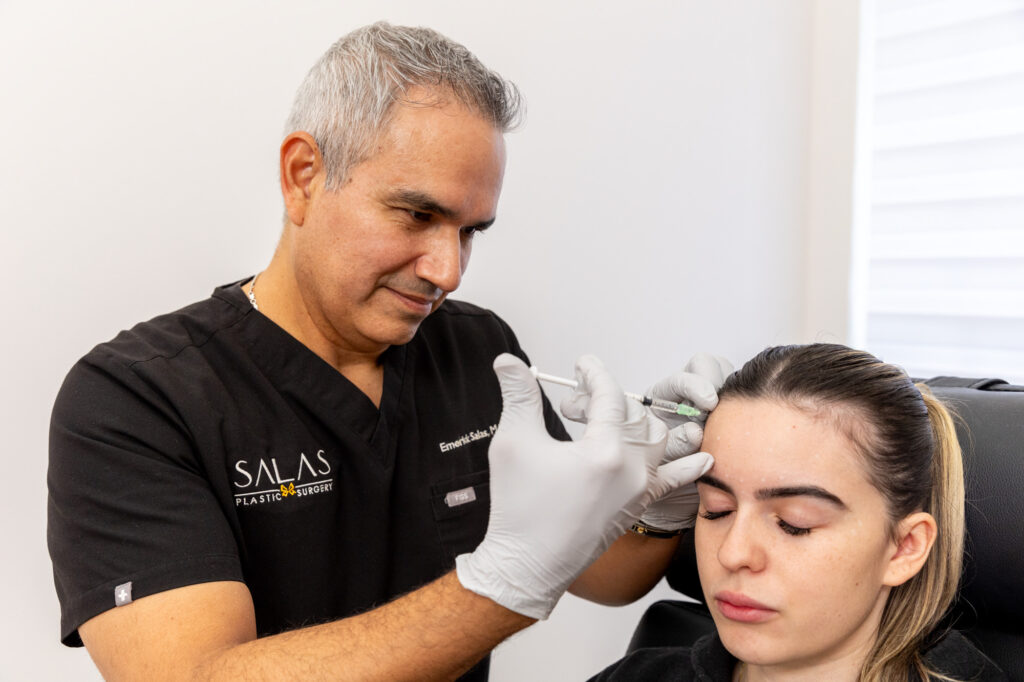 Dr. Salas performs Botox injections on a patient's forehead for facial balancing in Pembroke Pines.