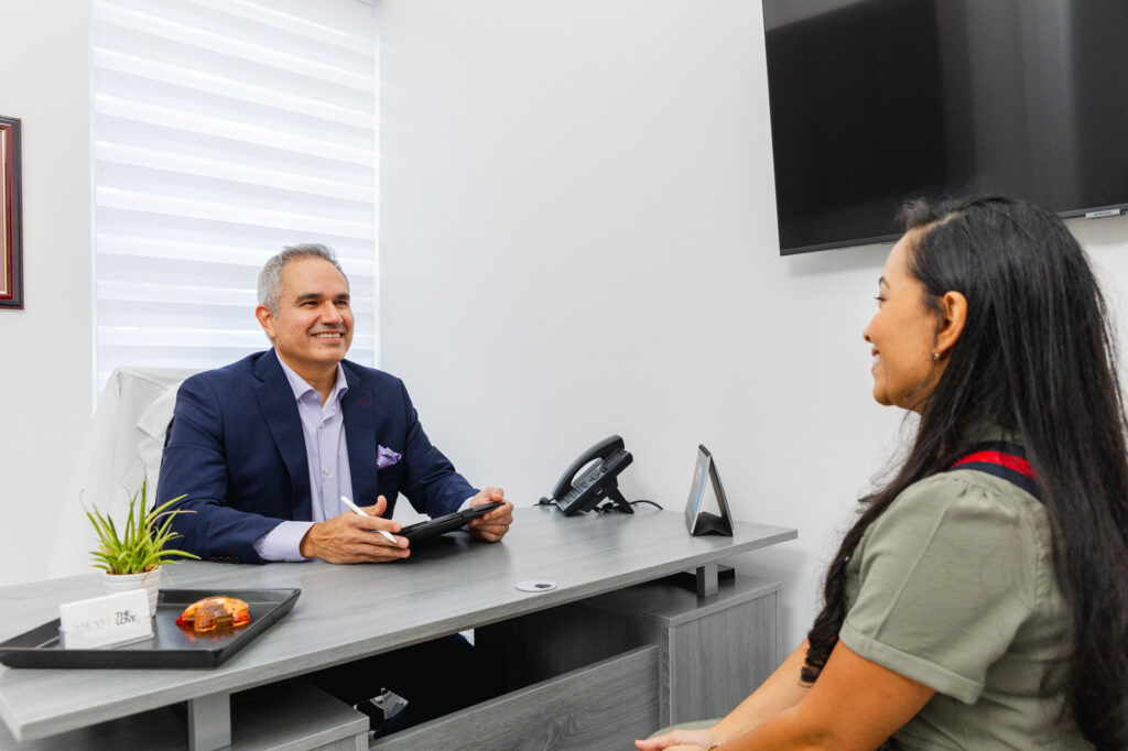 Dr. Salas meets with a female patient in his luxury-vibe office to discuss her options for a breast aug in Pembroke Pines.