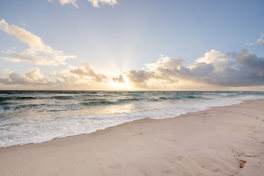 A gorgeous view of the beach and ocean waves at sunrise. It's part of the Miami vibe people enjoy when they come to Salas Plastic Surgery & The Love MedSpa for Latisse in Pembroke Pines.